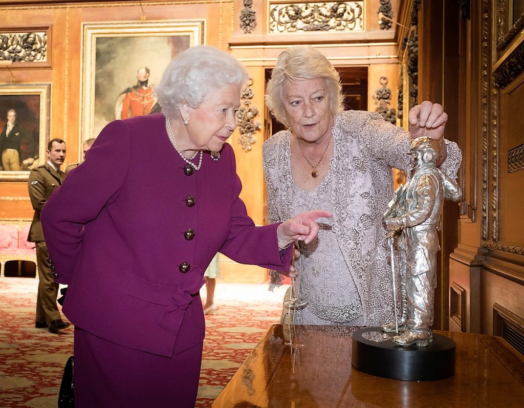 HRH The Queen with Vivien Mallock admiring the silver centrepiece sculpture celebrating the centenary of the Battle of Cambrai
