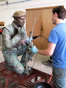 Simon begins the patina on Vivien Mallock's soldiers for the Devon and Dorset Regiment